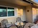 Covered porch with seating area and entryway to the home at 10604 W Camelot Cir, Sun City, AZ 85351