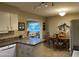 Kitchen with dining area, features a granite countertop and white cabinets at 10604 W Camelot Cir, Sun City, AZ 85351