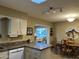 Kitchen with white cabinets and view of the dining area at 10604 W Camelot Cir, Sun City, AZ 85351