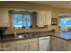 Bright kitchen features ample counter space and white cabinetry at 10604 W Camelot Cir, Sun City, AZ 85351