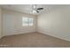 Bedroom with carpet, ceiling fan and exterior access at 1122 W Dragoon Ave, Mesa, AZ 85210