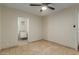 Bedroom with tile floors, ceiling fan and bathroom access at 1122 W Dragoon Ave, Mesa, AZ 85210