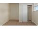 Bright bedroom with carpet, window, and closet at 1122 W Dragoon Ave, Mesa, AZ 85210