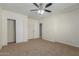 Bedroom with carpet, ceiling fan and exposed brick wall at 1122 W Dragoon Ave, Mesa, AZ 85210