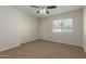 Bedroom with carpet, ceiling fan and exterior access at 1122 W Dragoon Ave, Mesa, AZ 85210