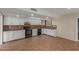 Kitchen with white cabinets, tile floors, and black appliances at 1122 W Dragoon Ave, Mesa, AZ 85210