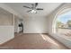 Living room featuring tile floors and arched window at 1122 W Dragoon Ave, Mesa, AZ 85210