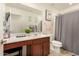 Clean bathroom with a vanity, shower, and gray shower curtain at 11695 N 166Th Ln, Surprise, AZ 85388