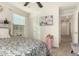 Bedroom with a queen bed, pink accent table, and hallway access at 11695 N 166Th Ln, Surprise, AZ 85388