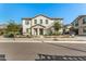 Two-story house with light-colored exterior, landscaping, and a gated entryway at 11695 N 166Th Ln, Surprise, AZ 85388