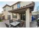 Covered patio with pavers, dining table, and grill at 11695 N 166Th Ln, Surprise, AZ 85388