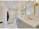 Elegant bathroom with double vanity, marble shower, and gold fixtures at 11776 N 119Th St, Scottsdale, AZ 85259