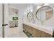 Basement bathroom with double vanity and circular mirrors at 11776 N 119Th St, Scottsdale, AZ 85259