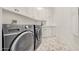 Spacious laundry room with washer, dryer, and ample cabinet storage at 11776 N 119Th St, Scottsdale, AZ 85259