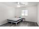 Bright bedroom with a double bed, ceiling fan, and gray vinyl flooring at 1208 E Hess Ave, Phoenix, AZ 85034