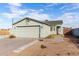 Single-story house with a two-car garage and landscaped yard at 1208 E Hess Ave, Phoenix, AZ 85034