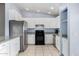 Kitchen boasts white cabinets, stainless steel appliances, and granite countertops at 1208 E Hess Ave, Phoenix, AZ 85034