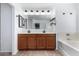 Bathroom with double vanity, tub, and shower at 12113 W Planada Ln, Sun City, AZ 85373