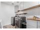 Laundry room with washer, dryer, and cabinets at 12113 W Planada Ln, Sun City, AZ 85373