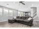 L-shaped sectional sofa in a living room with hardwood floors and access to the kitchen at 12113 W Planada Ln, Peoria, AZ 85383