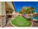 Landscaped backyard with a putting green, seating area, and pool at 12759 W Eagle Ridge Ln, Peoria, AZ 85383