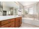 Bathroom with double vanity, soaking tub and large mirror at 12759 W Eagle Ridge Ln, Peoria, AZ 85383