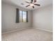 Bedroom with carpeted floor, ceiling fan, and window with gray curtains at 12759 W Eagle Ridge Ln, Peoria, AZ 85383