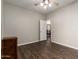 Bedroom with dark flooring, ceiling fan, and view into dining area at 12759 W Eagle Ridge Ln, Peoria, AZ 85383