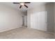 Bedroom with carpet, ceiling fan, and double door closet at 12759 W Eagle Ridge Ln, Peoria, AZ 85383