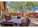 Outdoor seating area with tables and chairs under a tree at 12759 W Eagle Ridge Ln, Peoria, AZ 85383