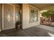 Front entry with security door, light fixture, and potted plant at 12759 W Eagle Ridge Ln, Peoria, AZ 85383