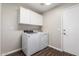 Laundry room with washer, dryer, and upper cabinets at 12759 W Eagle Ridge Ln, Peoria, AZ 85383