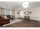 Living room with leather sofas, wood floors, and entryway view at 12759 W Eagle Ridge Ln, Peoria, AZ 85383