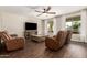 Living room with brown leather sofas and a rustic coffee table at 12759 W Eagle Ridge Ln, Peoria, AZ 85383