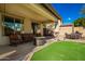 Covered patio with seating area and fire pit at 12759 W Eagle Ridge Ln, Peoria, AZ 85383