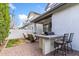 Paver patio featuring a built-in grill, bar seating, and lounge chairs in this comfortable outdoor living space at 1332 E Sierra Vista Dr, Phoenix, AZ 85014