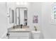 Modern bathroom with a single sink vanity, a decorative donkey print, and natural light from the window at 1332 E Sierra Vista Dr, Phoenix, AZ 85014