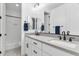 Bright bathroom featuring dual sinks with modern fixtures, white cabinets, and a shower-tub combo at 1332 E Sierra Vista Dr, Phoenix, AZ 85014