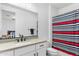 Bright bathroom featuring a single sink, white cabinets, a modern faucet, and a shower-tub combo at 1332 E Sierra Vista Dr, Phoenix, AZ 85014