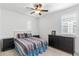 Bedroom with a ceiling fan, white shuttered windows, and wood furniture, including side tables and dresser at 1332 E Sierra Vista Dr, Phoenix, AZ 85014