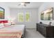 Comfortable bedroom featuring large windows with plantation shutters and a modern entertainment center at 1332 E Sierra Vista Dr, Phoenix, AZ 85014