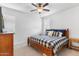 Bedroom featuring a wooden-frame bed with blue and white bedding, a ceiling fan, and natural light at 1332 E Sierra Vista Dr, Phoenix, AZ 85014