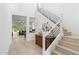 Bright hallway with modern staircase, light wood floors, and stylish decor at 1332 E Sierra Vista Dr, Phoenix, AZ 85014