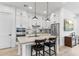 Modern kitchen featuring white cabinets, stainless steel appliances, and a large island with seating at 1332 E Sierra Vista Dr, Phoenix, AZ 85014