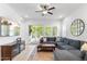 Cozy living room with a comfortable sectional sofa, ceiling fan, and sliding glass doors to the patio at 1332 E Sierra Vista Dr, Phoenix, AZ 85014