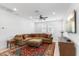 Bright living room featuring a ceiling fan, large sectional sofa, and a decorative area rug at 1332 E Sierra Vista Dr, Phoenix, AZ 85014