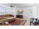 Bright living room featuring a ceiling fan, large sectional sofa, and a decorative area rug at 1332 E Sierra Vista Dr, Phoenix, AZ 85014