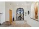 Grand entryway features a beautiful arched iron door at 13512 N Granite Way, Fountain Hills, AZ 85268