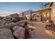 Stunning desert landscape surrounds this home's exterior, showcasing its architectural details at 13512 N Granite Way, Fountain Hills, AZ 85268