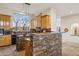 Island kitchen with wood cabinets and stone accents at 13512 N Granite Way, Fountain Hills, AZ 85268